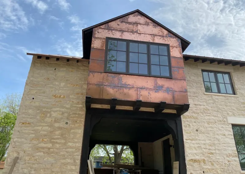 Copper metal panel facade on a stone building for Skylight Installation in EspaÃ±ola