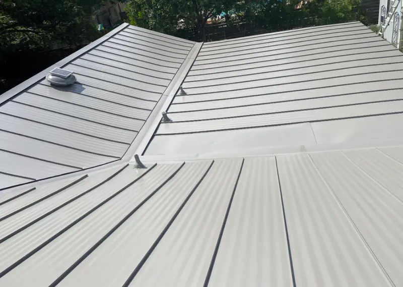 Solar attic fan installed on a metal roof for Roof Ventilation in EspaÃ±ola