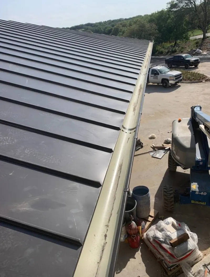 Standing seam panel and gutter detail on a metal roofing jobsite in EspaÃ±ola